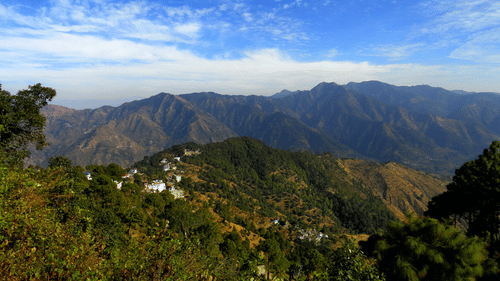 Green misty mountains under the dramtic cloud sky