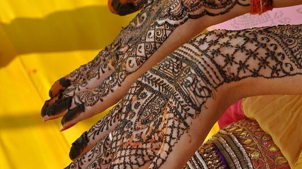 Deo Bagh - 17th Century, Gwalior - a woman showing her hand designed in mehndi