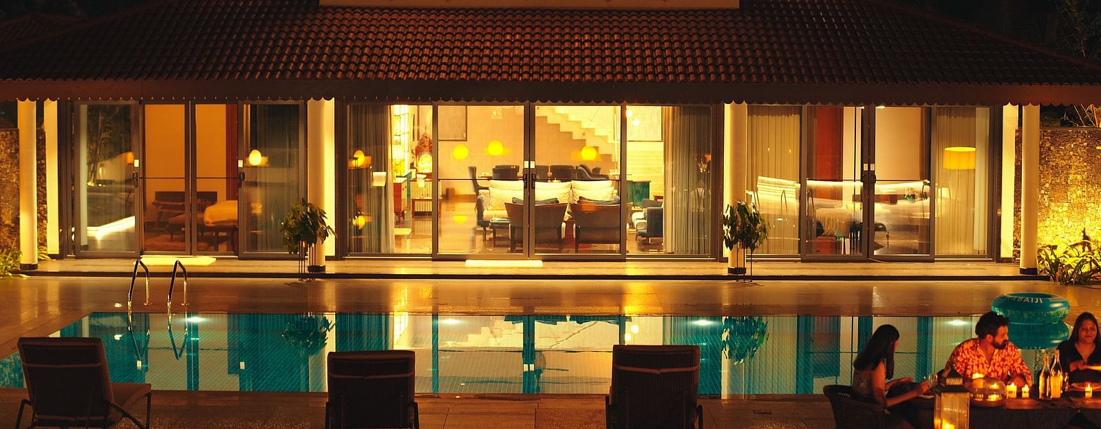 overview of the swimming pool at night in the luxurious villa - Gamyam Retreat