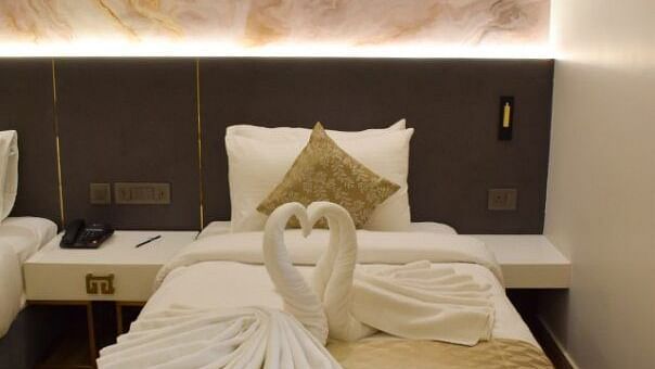 Close up shot of the twin bed with dove made of towels on it inside executive room at Tulip Inn, Shravasti