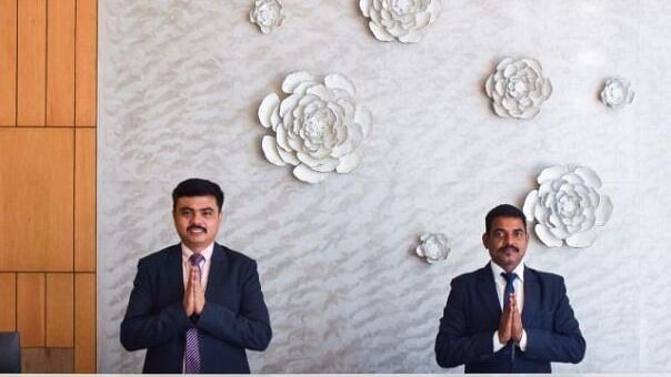 Staff greeting behind the reception desk at Tulip Inn, Shravasti