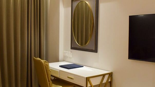 Study table with mirror on the wall inside executive room at Tulip Inn, Shravasti