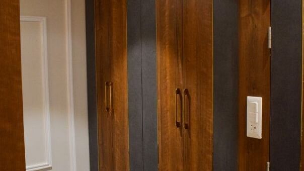 Wardrobe with wooden doors inside suite at Tulip Inn, Shravasti