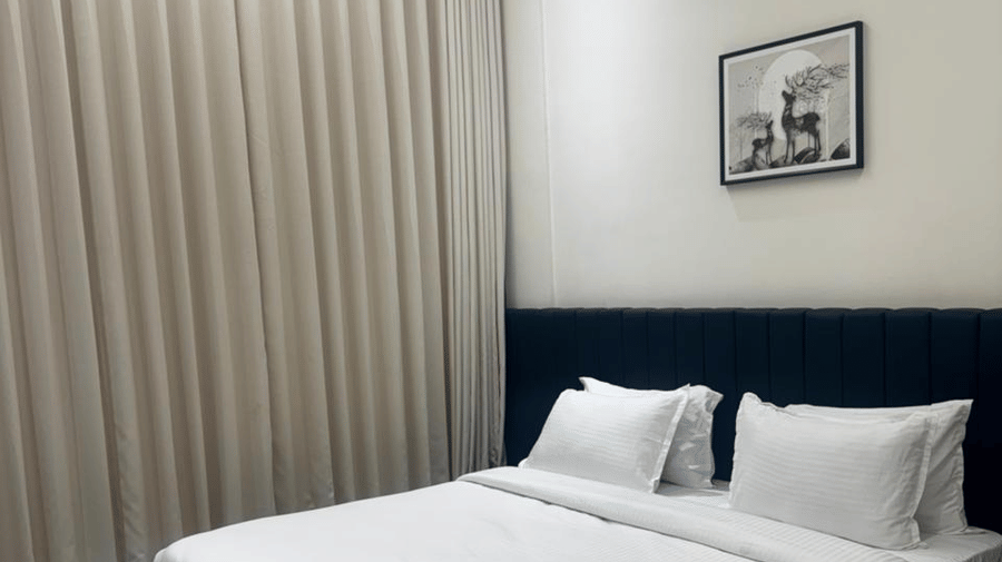 Compact and comfortable guest room with ambient lighting - Lords Swastik Studio, Kodinar