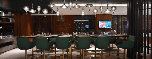 A sleek bar lounge featuring green bar stools and ambient lighting, designed for upscale dining and drinks.