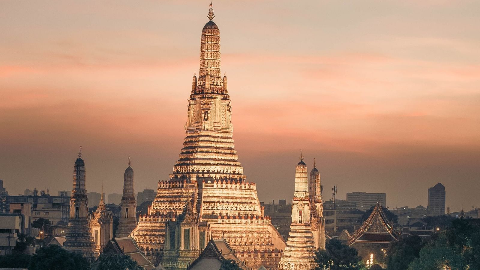 an overview showcasing the famous Sunset at Wat Arun with a lake and a boat in front.