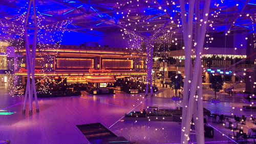 An overview of a mall with entrance to the cheesecake factory at the end