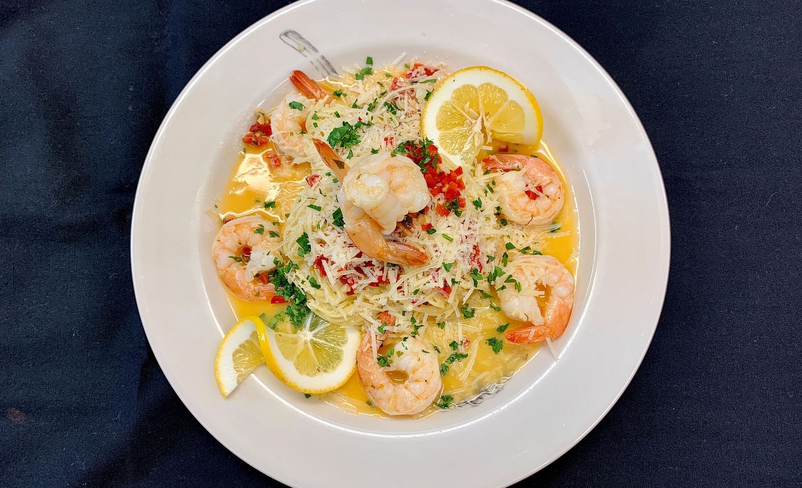 A creamy seafood risotto served on a white plate - Brewery Gulch Inn & Spa