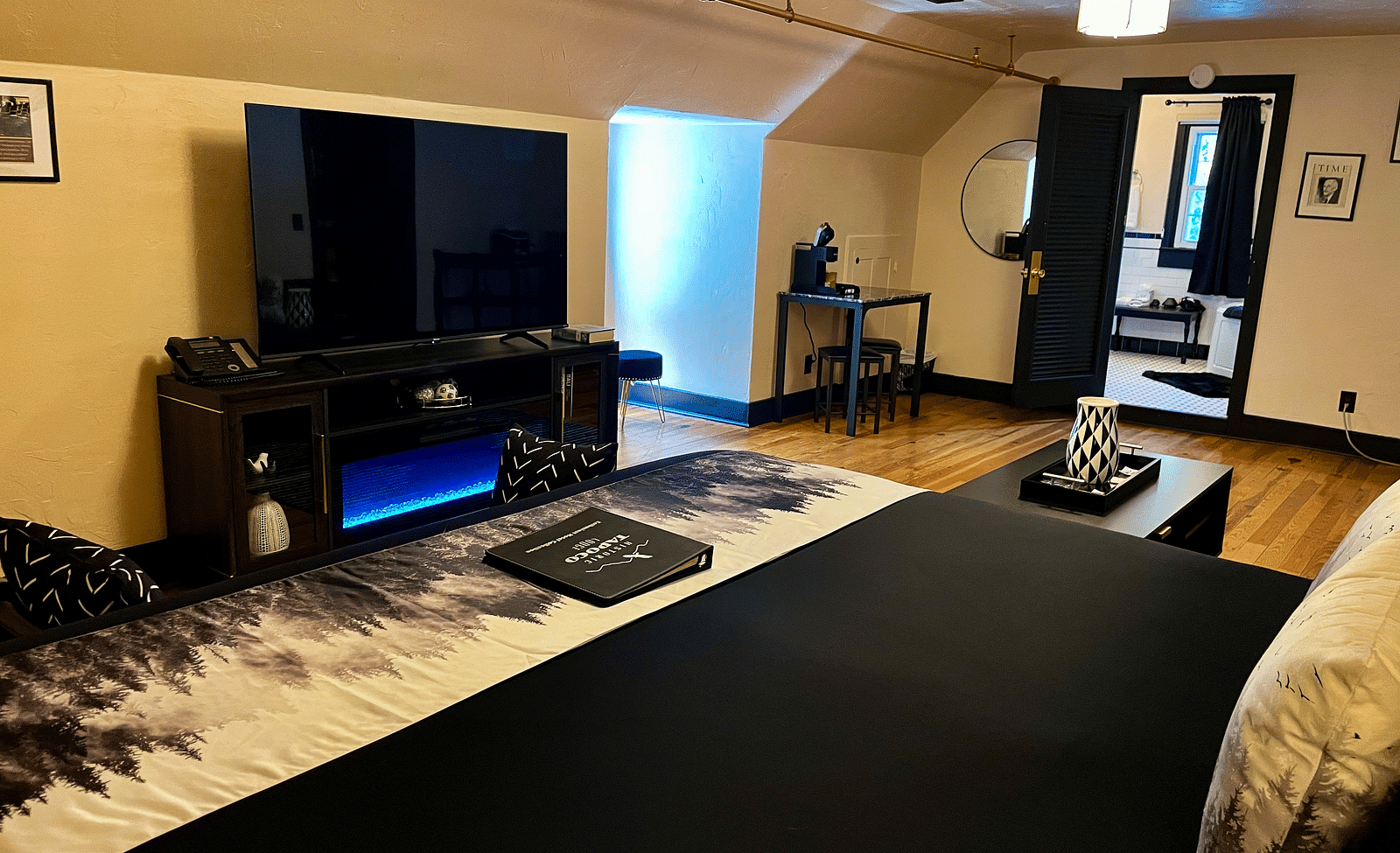 corner view of a room overlooking the double bed and wide flat screen television - Historic Tapoco Lodge