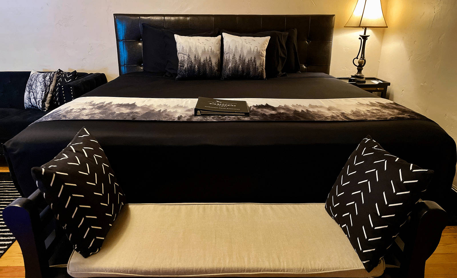 front view image of the double bed along with a small seating place in front of it - Historic Tapoco Lodge