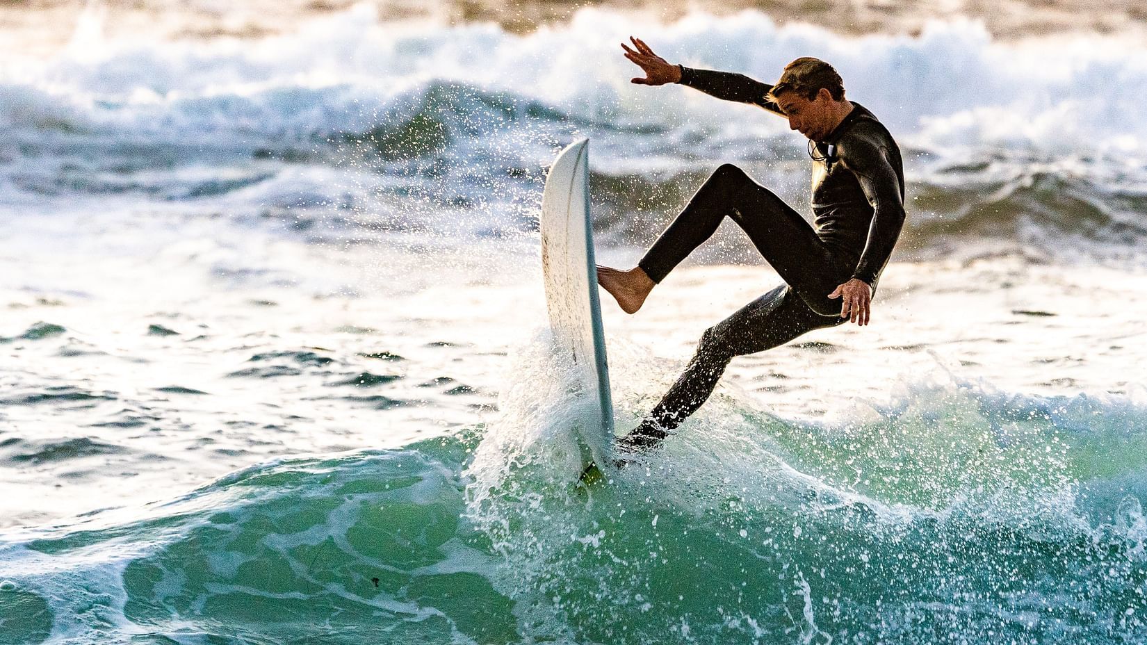 A man surfing in blue waters