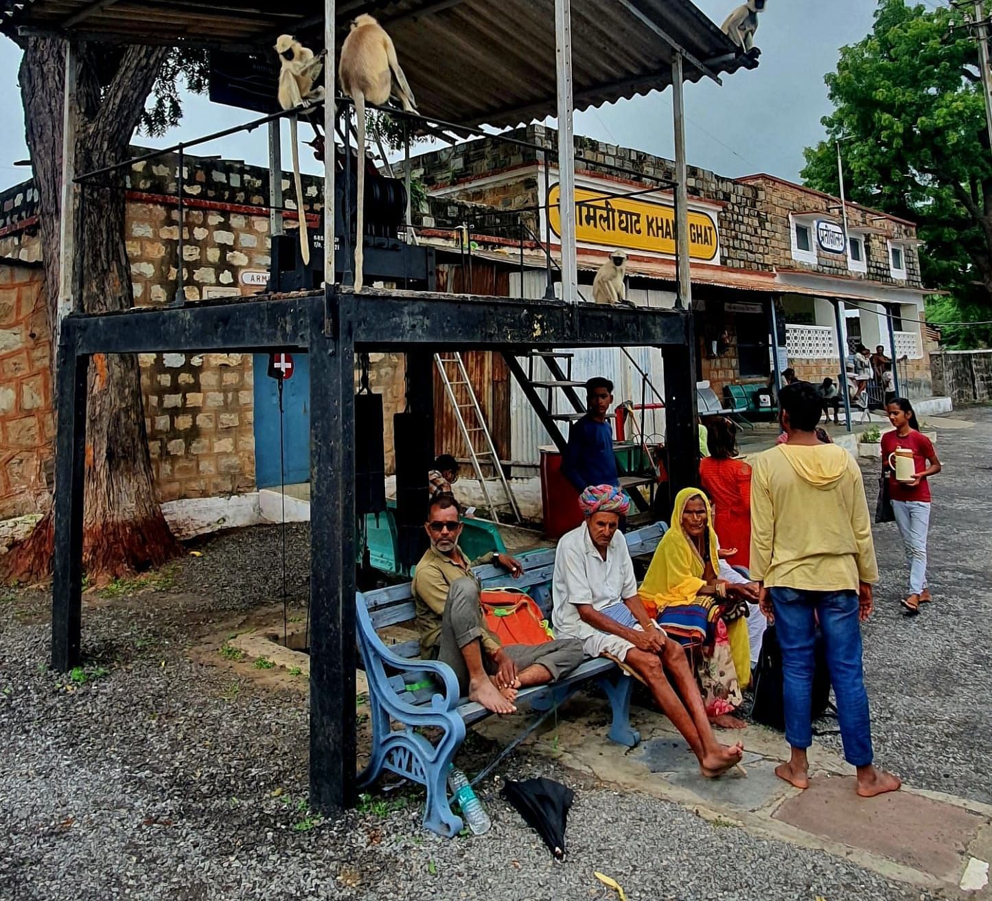image of a few villagers waiting at a train station
