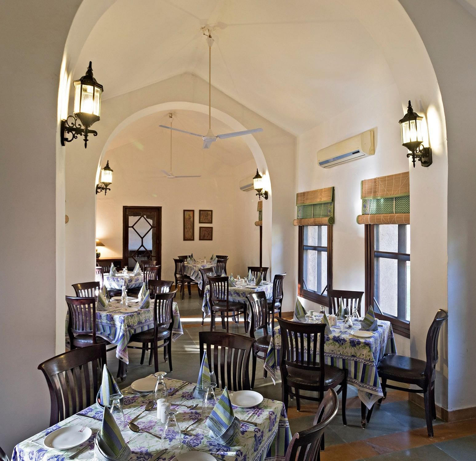 An image of the seating arrangement at with minimal decoration Taasli Restaurant of Manvar Shergarh - Manvar Resort & Desert Camp