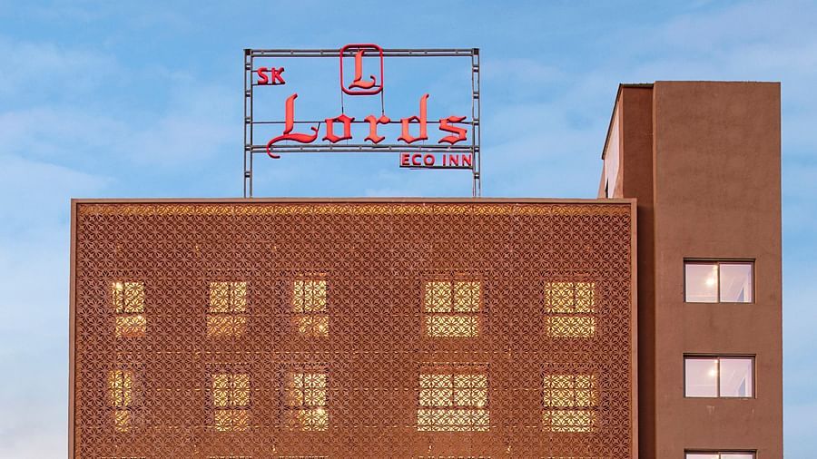 An exterior view of a modern, multi-storey hotel building - SK Lords Inn Ahmedabad