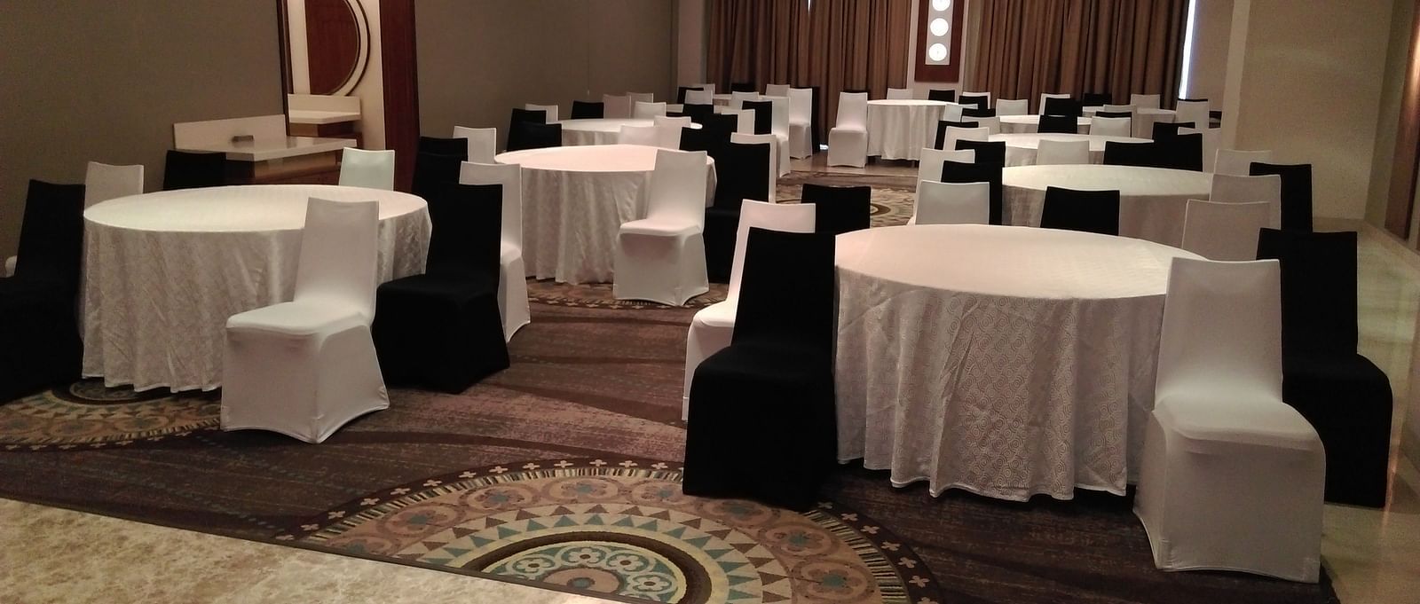 A hall with round tables and chairs around it The Raintree Hotel, St. Mary's Road.