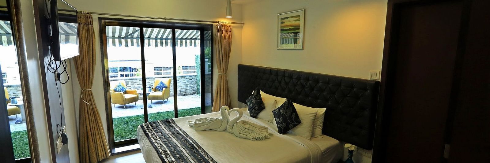Premuim Garden Terrace Room with bed and large windows at The Oriental Residency