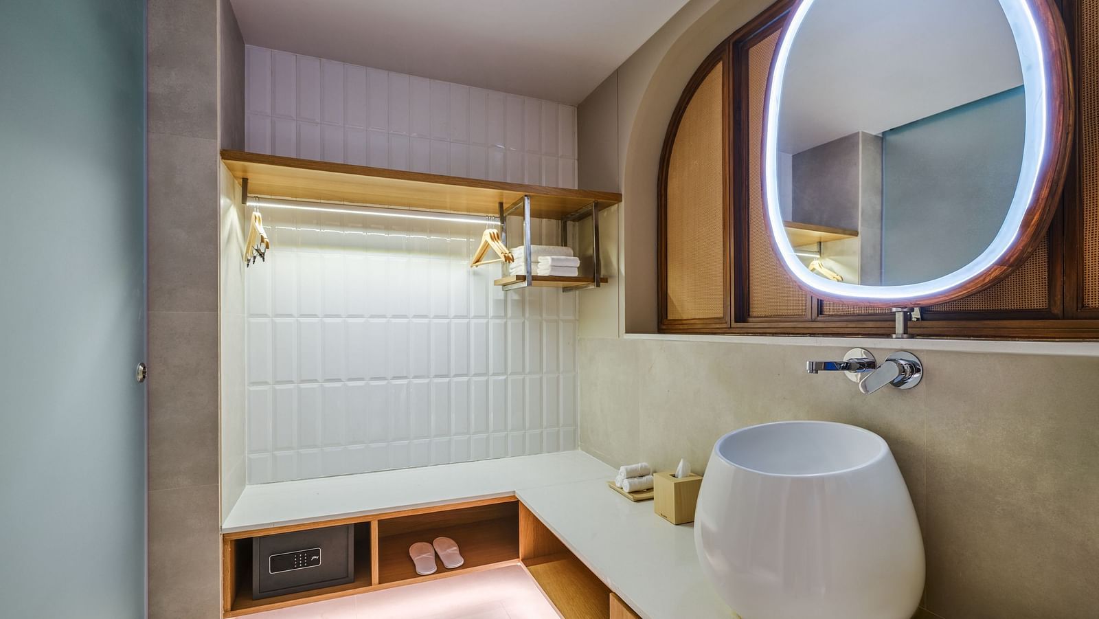 An image of the bathroom featuring ambient lighting and toiletries and a secret locker underneath the slab