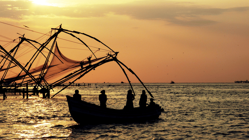 An overview of fishermen using Chinese nets from their boat to catch fishes.