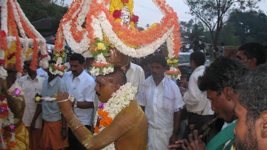 An image Coorg Festival where the priest is carrying the goddess on a road show  , Amanvana Resort and Spa, Things To Do In Coorg