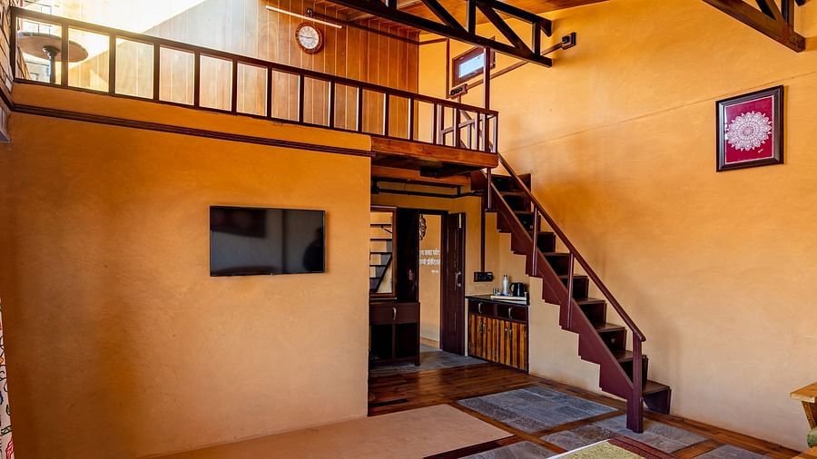 Cosy loft-style room with earthy tones, a staircase, and a minimalist rustic charm. - Blusalzz Homes The Himalayan Bungalow, Almora