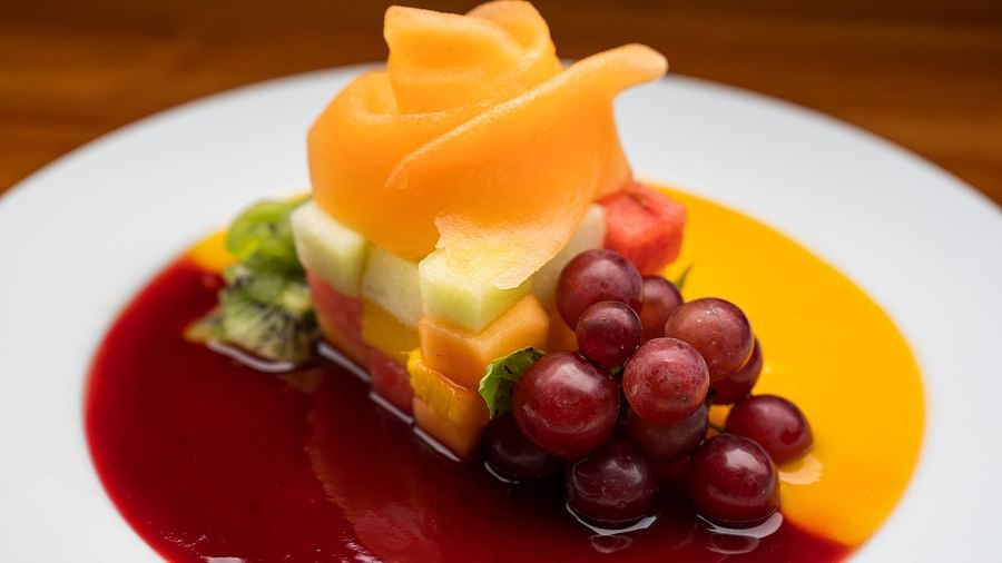 A dessert with fruits and sauce presented on a white plate - S Hotel Montego Bay, Jamaica