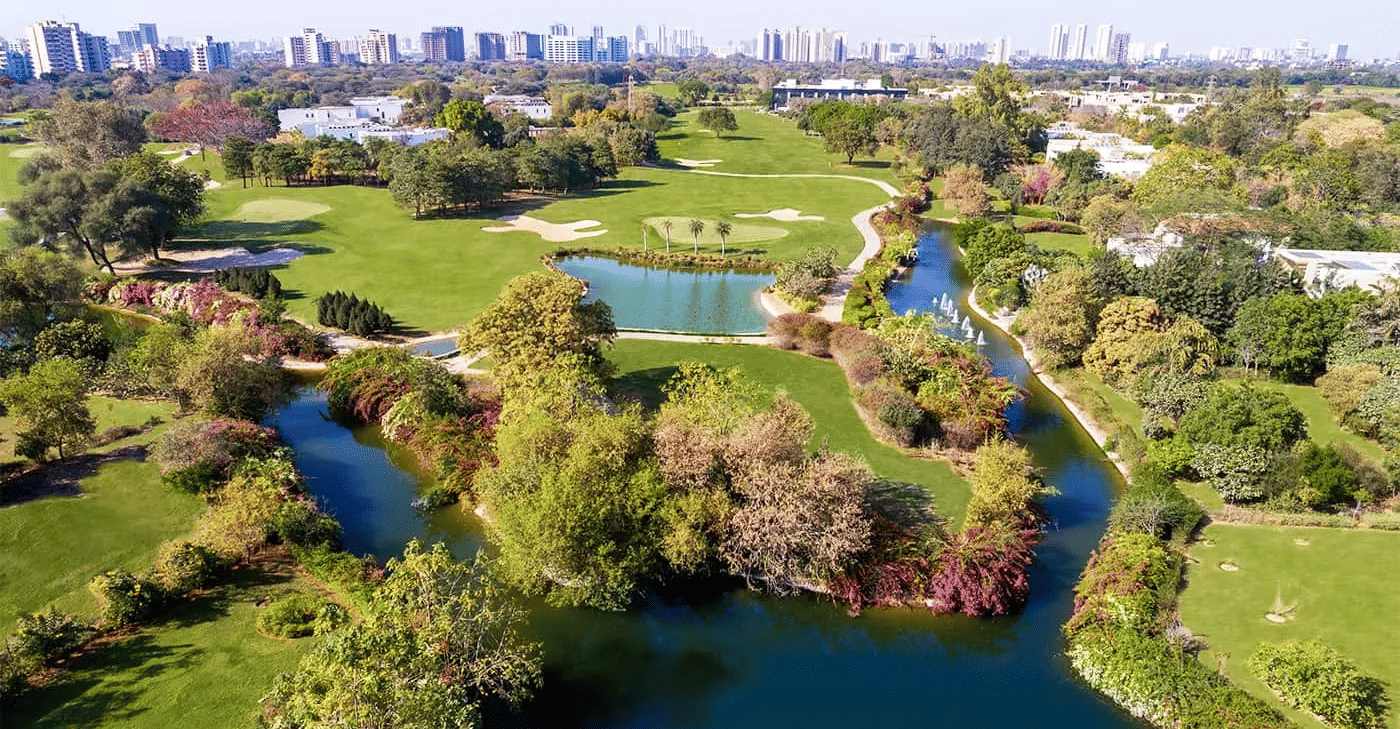Aerial view of a golf course and surrounding trees at Karma Lakelands.