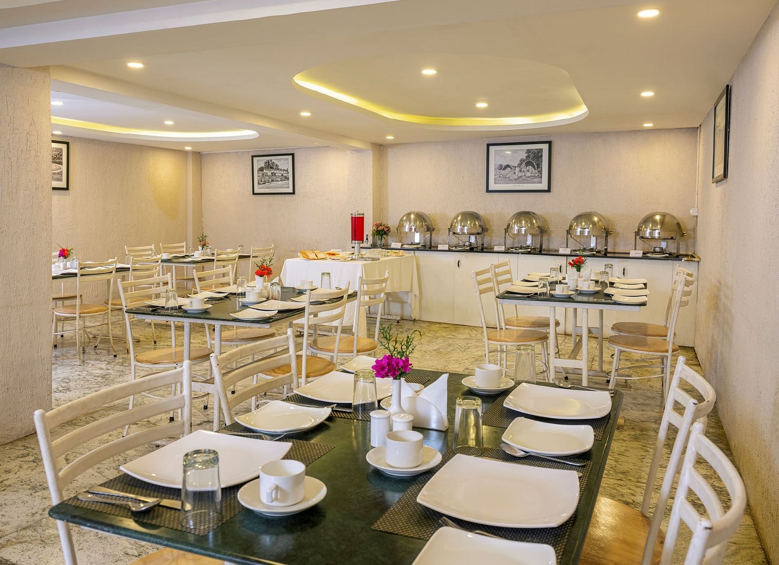 Elegant restaurant interior with buffet tables and decorative lighting | Mango HIll Central, Ooty