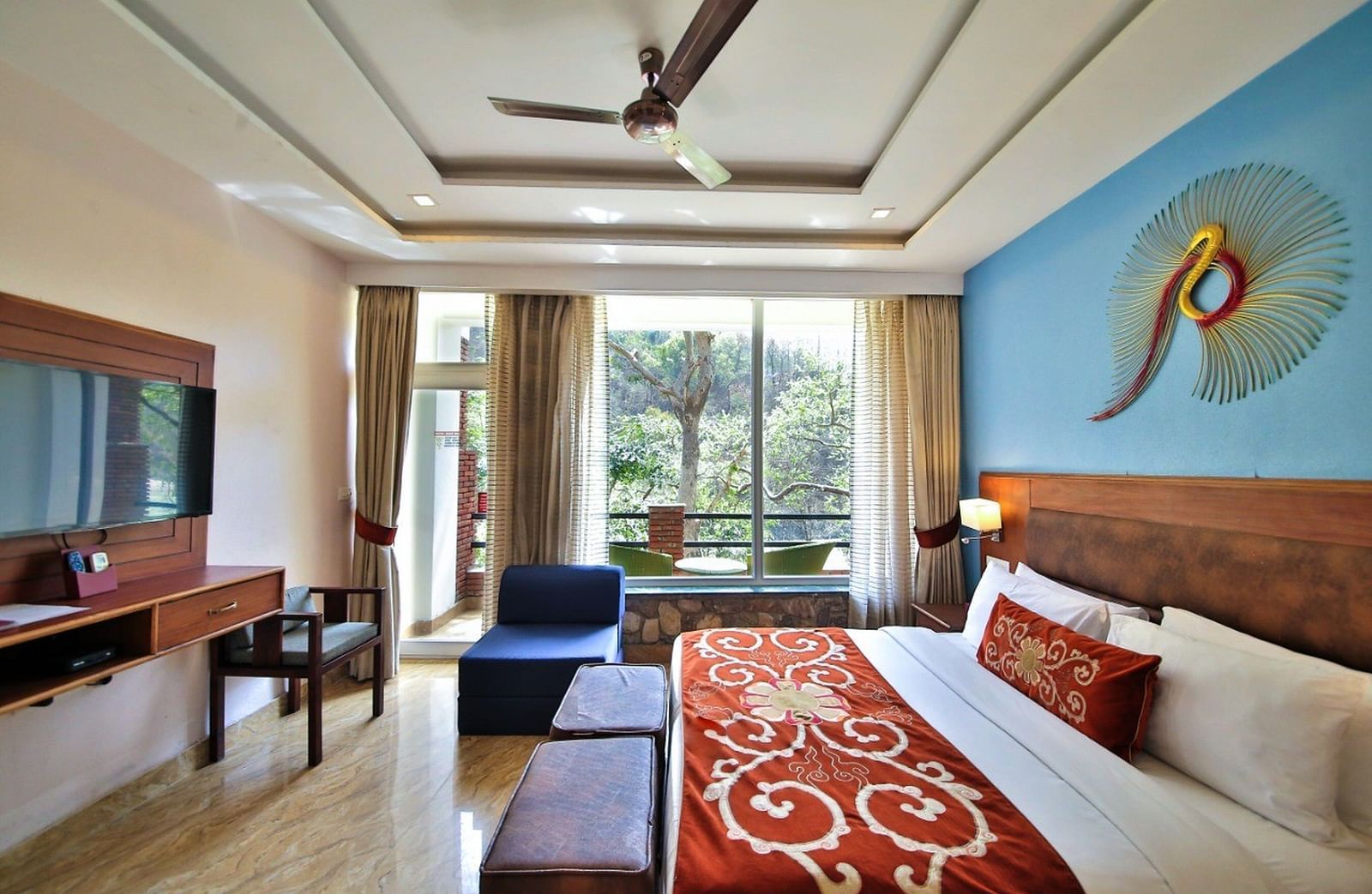 Premium Room witt seating area, bed and a televisoon i front of it at Summit By The Ganges Beach Resort & Spa, Rishikesh