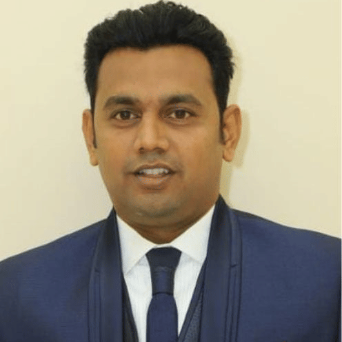 Corporate Manager Business Development in formal attire at Pride Hotels Group.