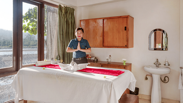 Resort spa treatment room with massage table and relaxing ambiance.