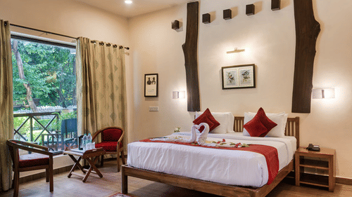 Tranquil resort bedroom with picturesque view of the surrounding landscape.