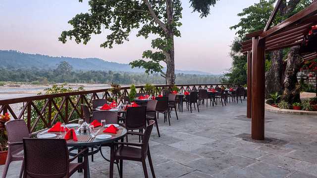 Outdoor dining area with scenic views of the river and surrounding landscape.