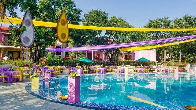 alt-text Festive poolside wedding venue with colorful decorations.