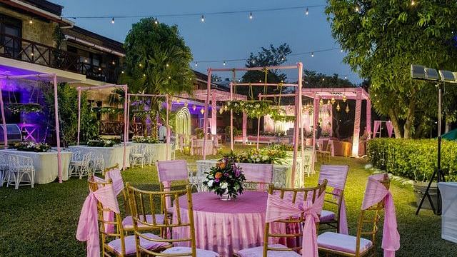 alt-text Outdoor wedding reception with tables and chairs.