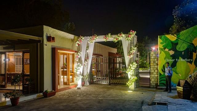 alt-text Festive entrance with fairy lights and floral arrangements.