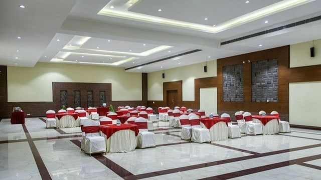 alt-text Large event room with tables set for a formal gathering or conference.