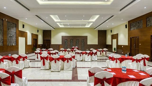 alt-text Large event room with tables set for a formal gathering or conference.