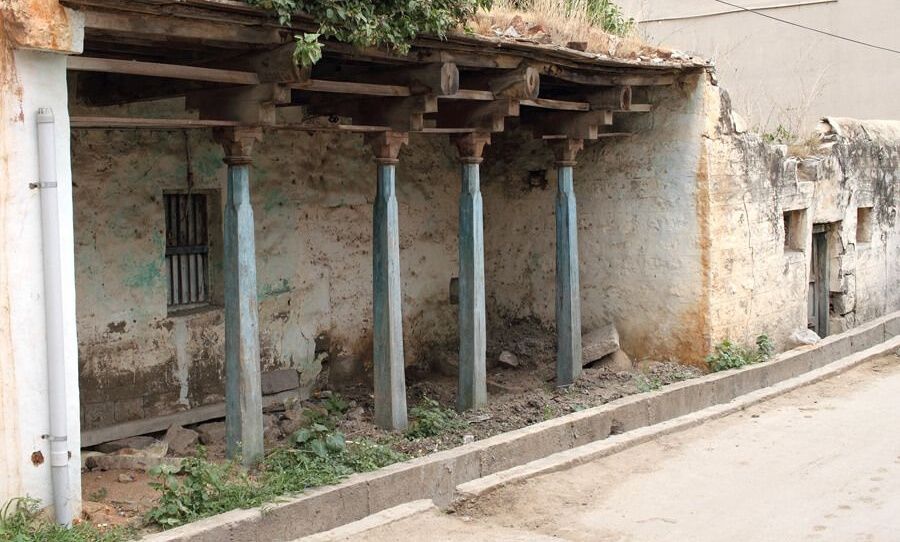Old house in Anegudi village with blue pillars.