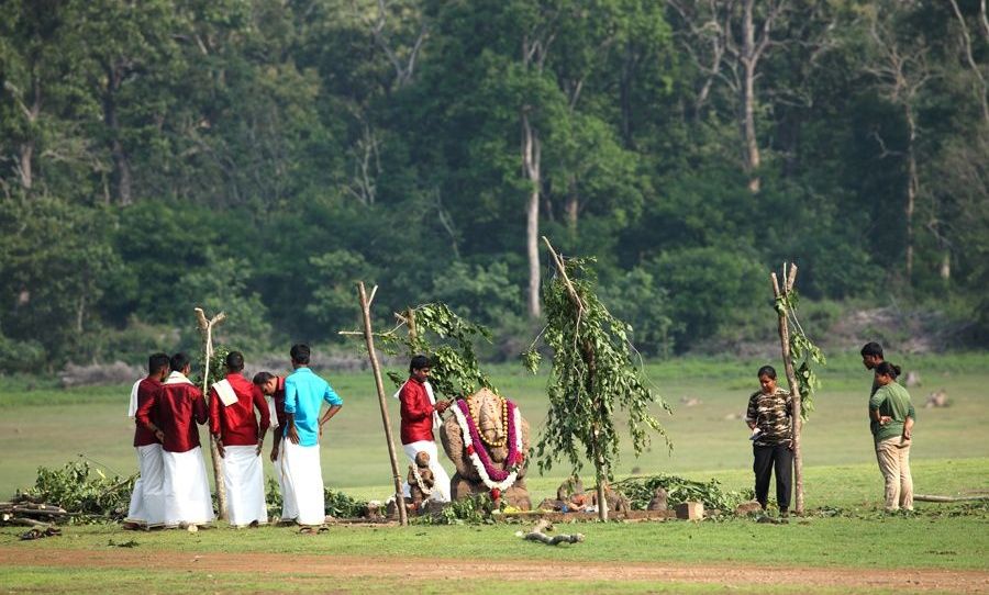 People in traditional attire performing a ritual.