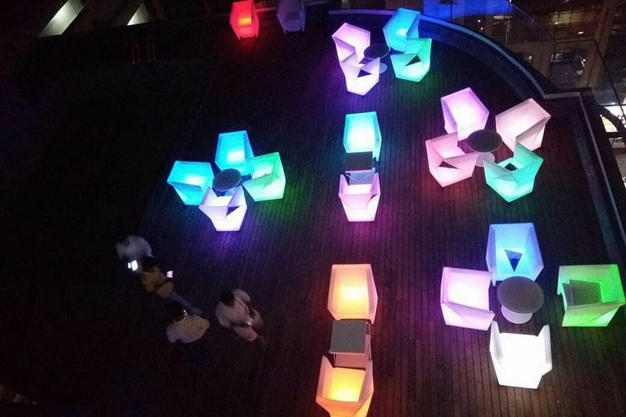 The Empresa Boutique Hotel - aerial view of the rooftop area with colourful seats beside the swimming pool