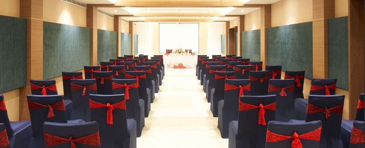 rear view of the hall with well arranged chairs at Grand Kakinada by GRT Hotels