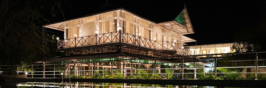 A picture featuring the exterior of the well lit building in the night