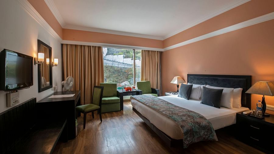 Premier Room with a bed overlooking a window at Mastiff Grand, Manali