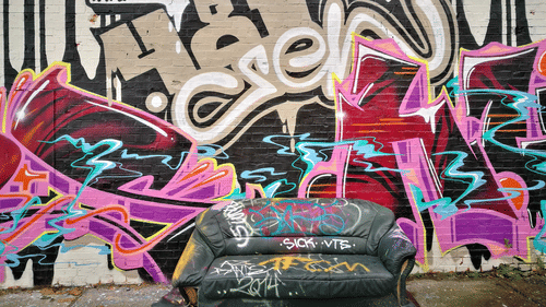 A wall painted into a design using colourful spray