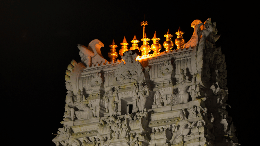 The vibrant building of Sri Govindaraja Swamy Temple in Tirupati, as seen during the night, with intricate art on the roof.