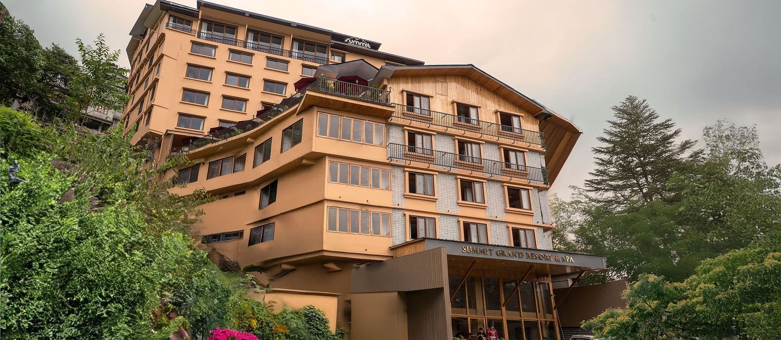 Facade image of Summit Grand Resort & Spa, Gangtok, with trees lining the pathway