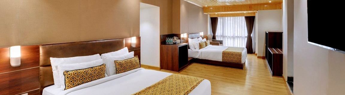 An image of a room with two queen size beds, TV and minimal decoration - Sumitel Vista TV Tower