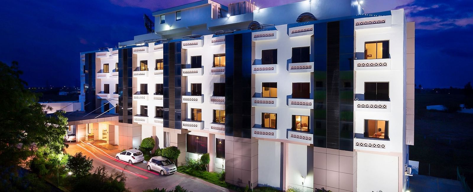 The exterior facade of a hotel building illuminated by warm lights - Regency Tuticorin by GRT Hotels, Best Hotel in Tuticorin