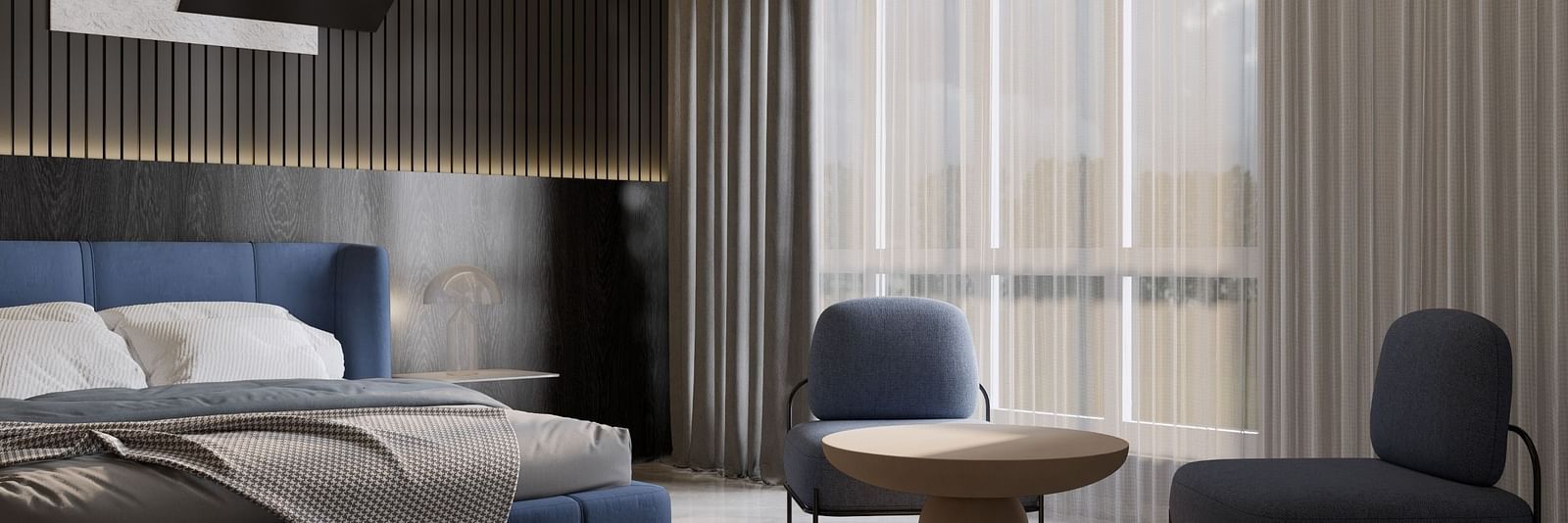 A stylish hotel room with a plush blue bed, modern decor, seating area, and floor-to-ceiling curtains at Town Square Suites.