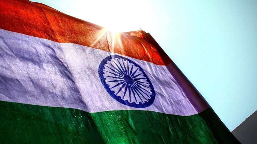 the Indian Flag shining with the sun in the backdrop